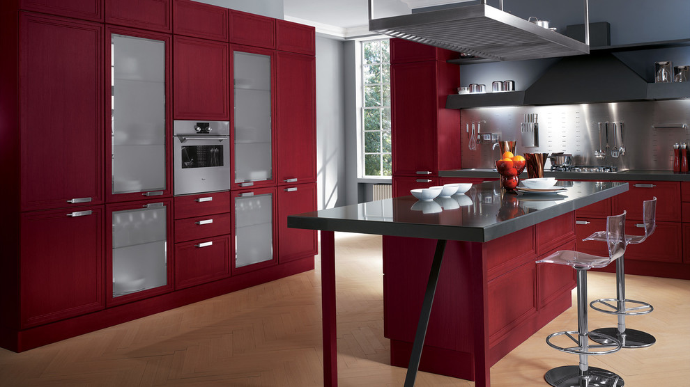 Large modern l-shaped eat-in kitchen in Melbourne with a double-bowl sink, raised-panel cabinets, red cabinets, quartz benchtops, metallic splashback, light hardwood floors and multiple islands.