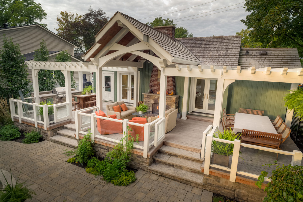 Photo of a mid-sized contemporary backyard patio in Toronto with an outdoor kitchen, decking and a pergola.