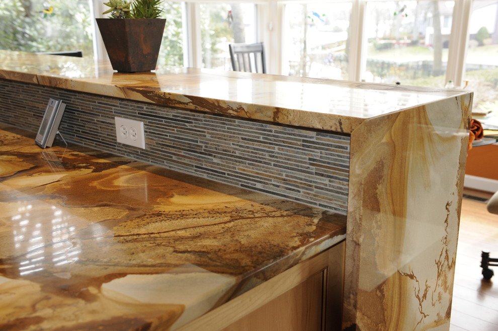 Example of a mid-sized transitional u-shaped light wood floor eat-in kitchen design in Baltimore with a farmhouse sink, beaded inset cabinets, light wood cabinets, onyx countertops, stainless steel appliances and an island