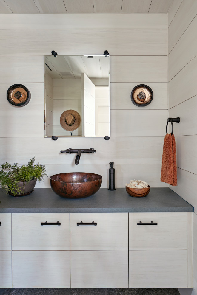 Inspiration for a mid-sized country bathroom in New York with a vessel sink, beige cabinets, beige walls, grey benchtops, wood and wood walls.