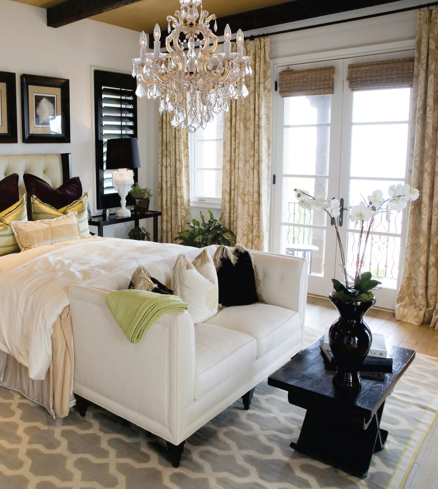 Design ideas for a mid-sized transitional guest bedroom in New York with white walls and light hardwood floors.