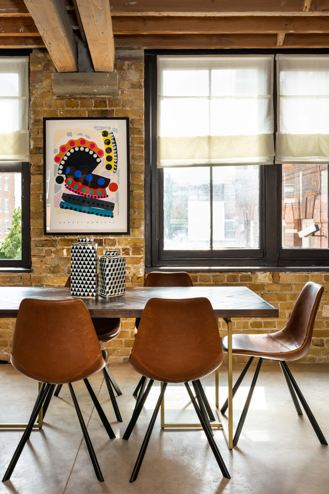 Large industrial open plan dining in London with brown walls, grey floor and brick walls.