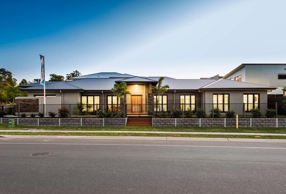 Design ideas for a large contemporary one-storey brown exterior in Brisbane with stone veneer and a hip roof.