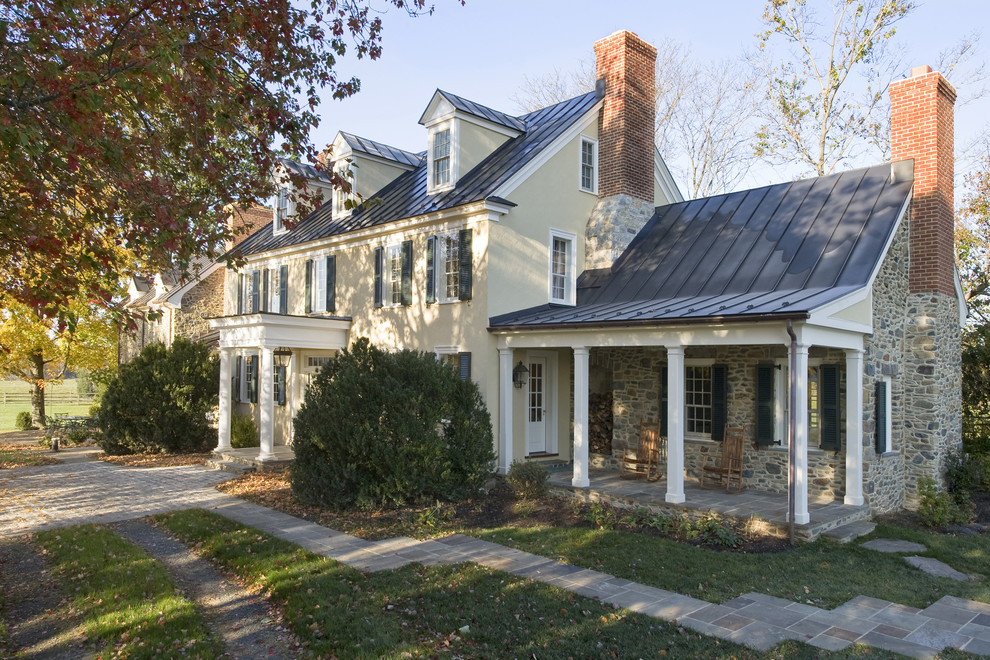 This is an example of a mid-sized traditional three-storey stucco beige exterior in DC Metro.
