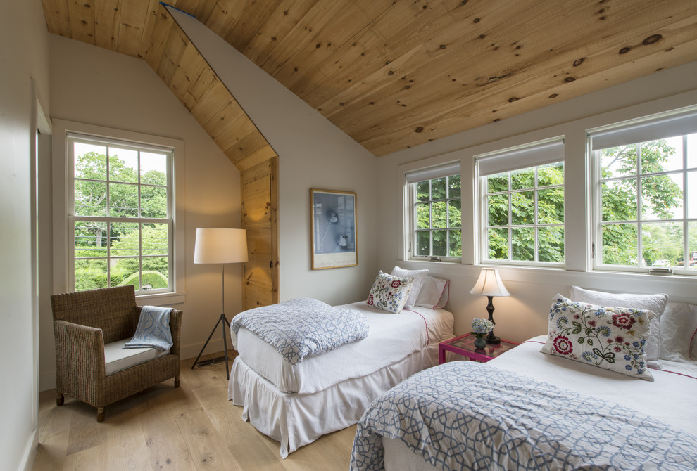 Mid-sized country guest bedroom in Providence with white walls and light hardwood floors.