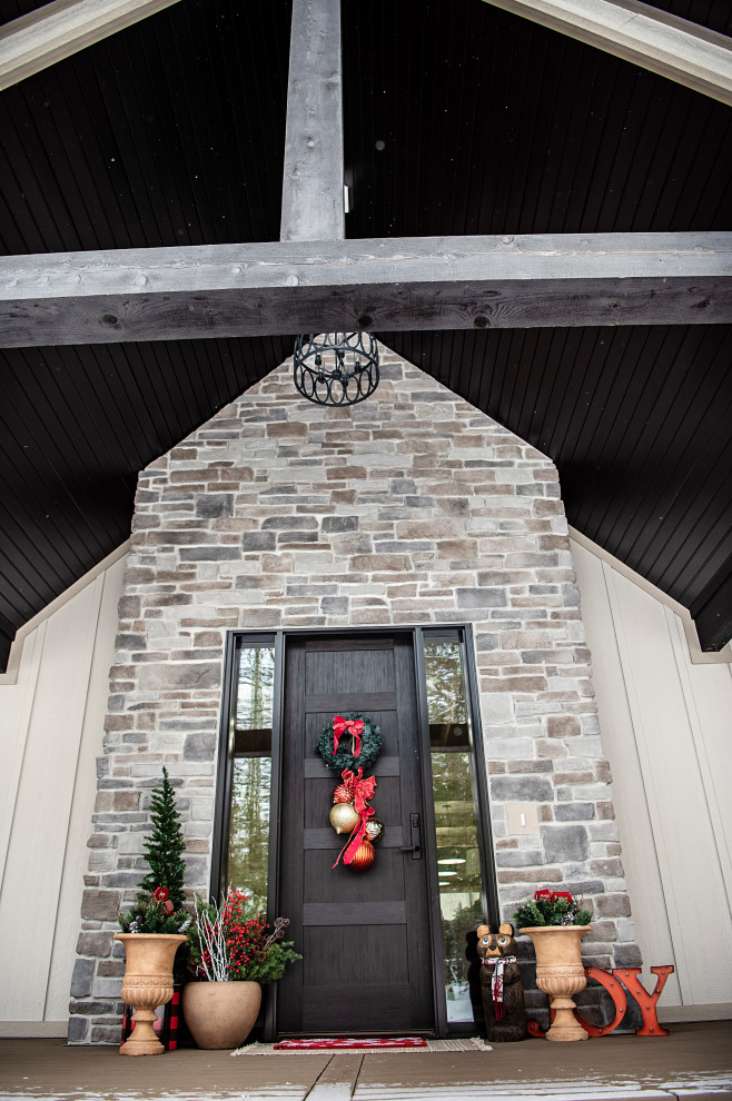 Inspiration for a large rustic foyer remodel with a black front door