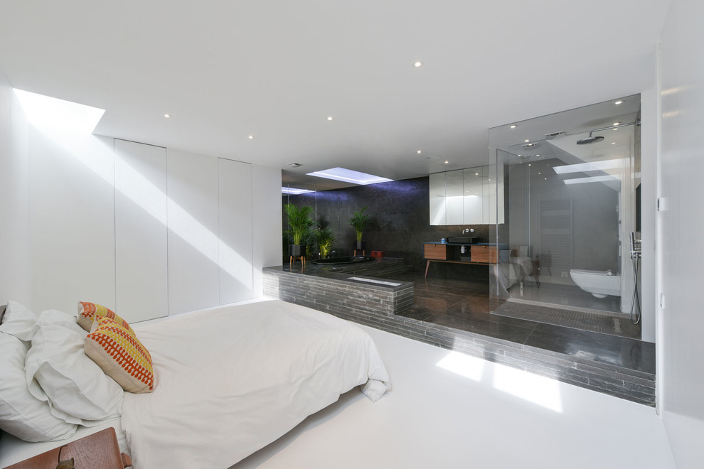 Photo of a large contemporary bedroom in London with white walls and white floor.