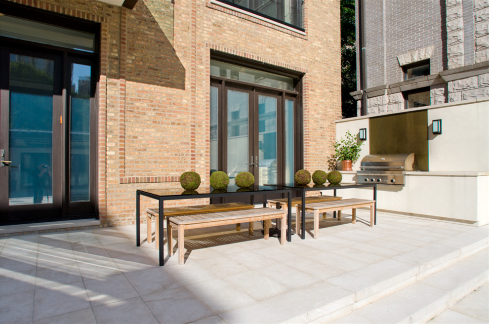 Inspiration for a large contemporary backyard patio in Chicago with no cover and natural stone pavers.