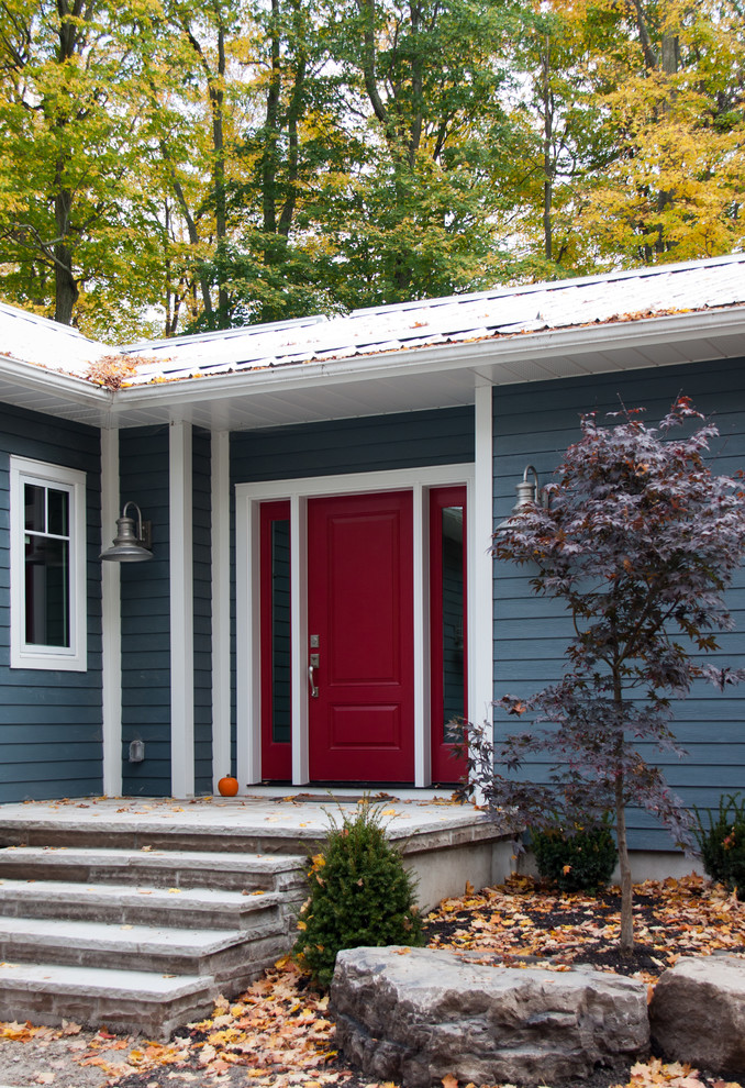 Photo of a traditional front door in Toronto with a single front door and a red front door.