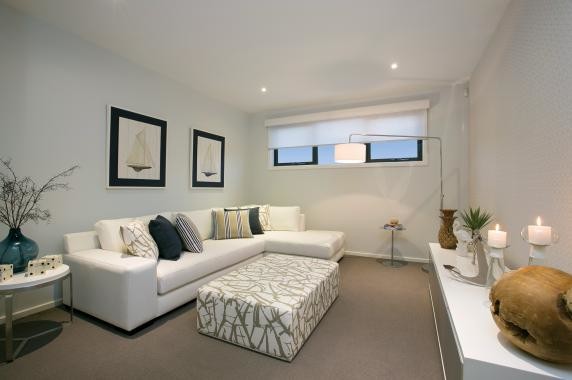 Photo of a mid-sized beach style open concept home theatre in Melbourne with blue walls, carpet, a wall-mounted tv and beige floor.
