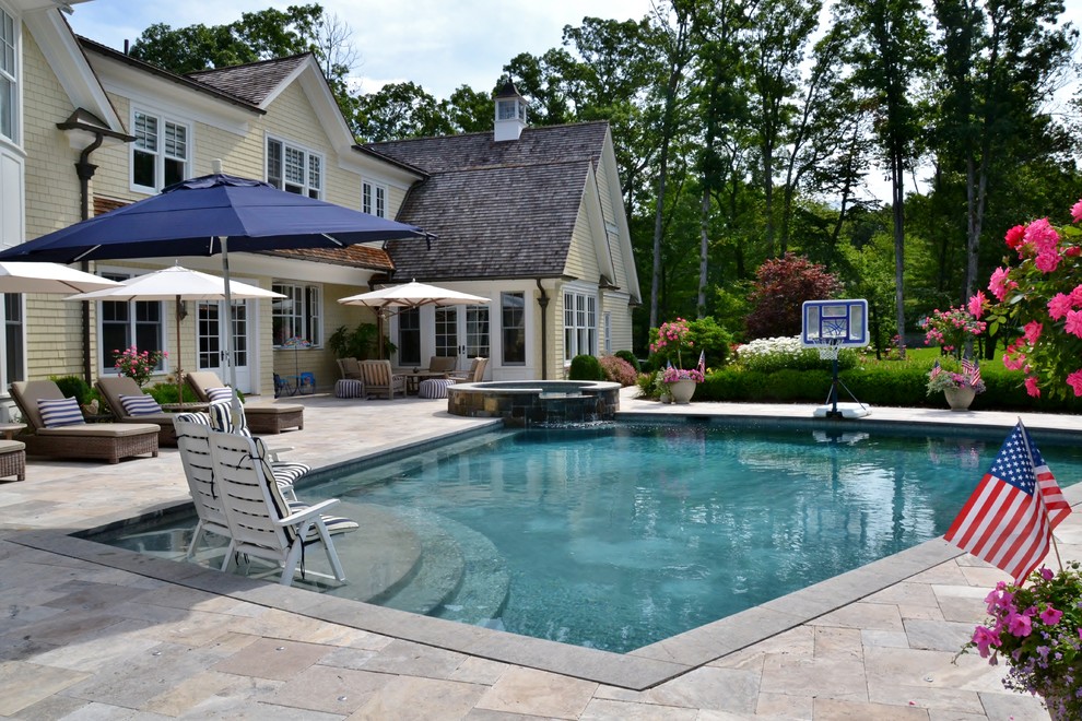 Large contemporary backyard custom-shaped pool in New York with a hot tub.