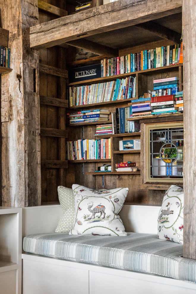 Inspiration for a rustic open plan living room in Boston with a reading nook, a standard fireplace, a stone fireplace surround and exposed beams.