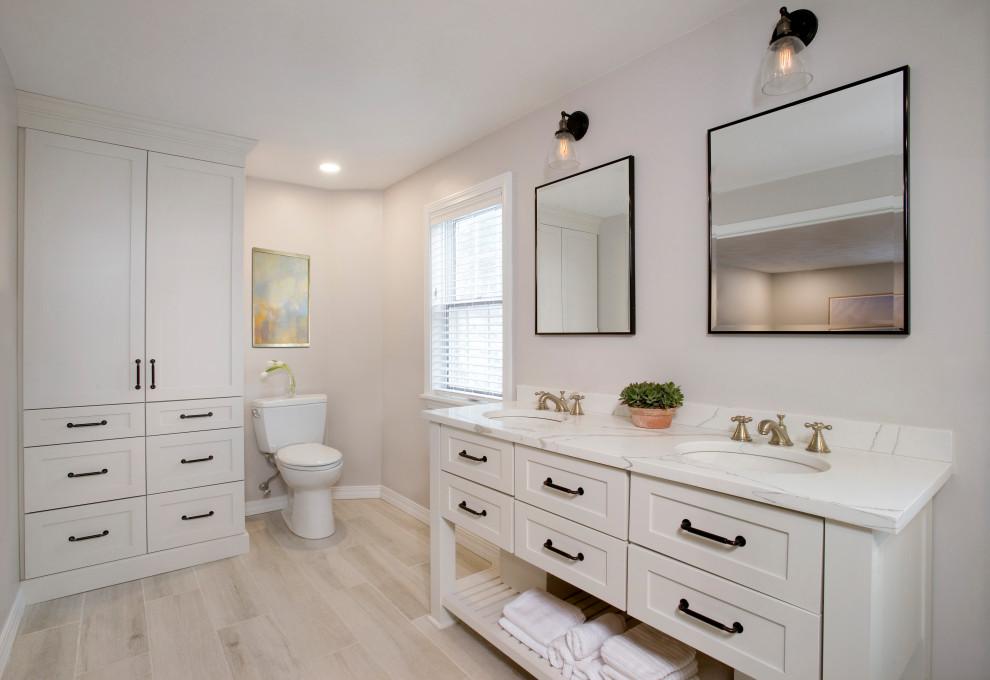 Design ideas for a large country master wet room bathroom in Boston with furniture-like cabinets, white cabinets, a freestanding tub, a one-piece toilet, white tile, porcelain tile, beige walls, wood-look tile, an undermount sink, engineered quartz benchtops, beige floor, an open shower, white benchtops, a double vanity and a freestanding vanity.