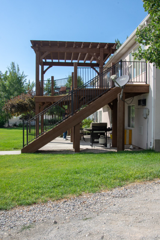 Inspiration for a large traditional backyard deck in Salt Lake City with a pergola.