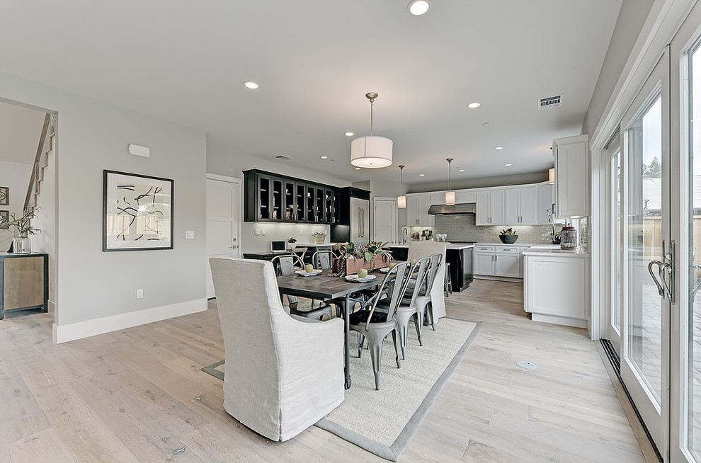 Large transitional kitchen/dining combo in San Francisco with grey walls and light hardwood floors.