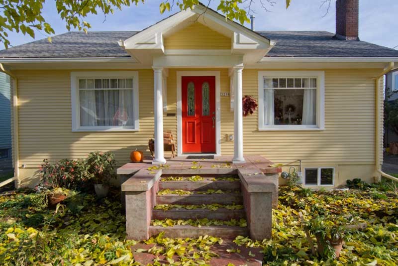 Inspiration for a mid-sized arts and crafts one-storey yellow exterior in Portland with wood siding.