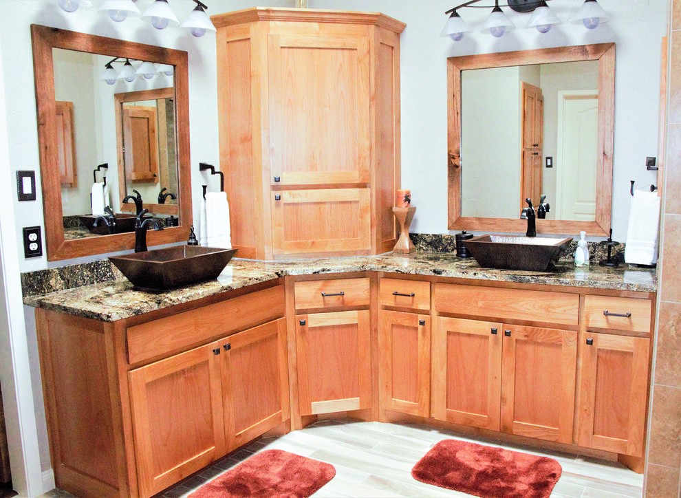 Design ideas for a large arts and crafts master bathroom in Dallas with shaker cabinets, brown cabinets, a drop-in tub, an open shower, a one-piece toilet, beige tile, ceramic tile, beige walls, ceramic floors, a vessel sink, granite benchtops, beige floor and an open shower.