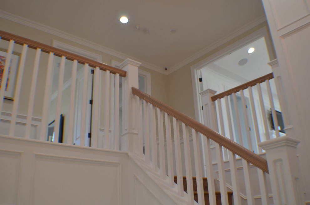 Photo of a mid-sized traditional wood curved staircase in Los Angeles with wood risers and wood railing.