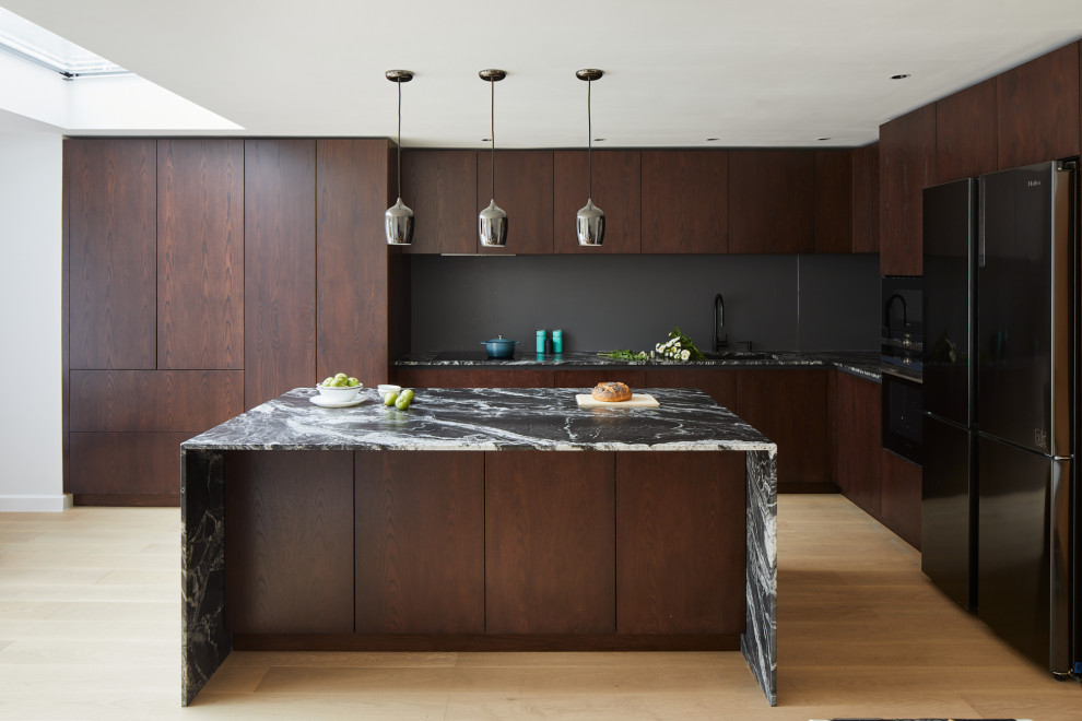 Design ideas for a large contemporary l-shaped kitchen/diner in London with flat-panel cabinets, dark wood cabinets, granite worktops and an island.