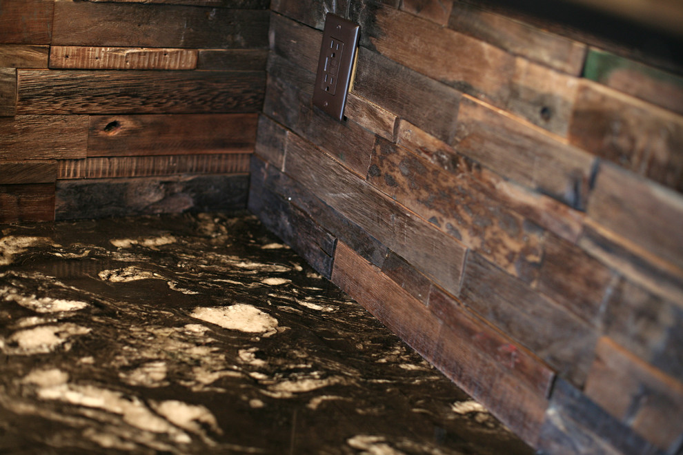 Example of a mid-sized mountain style l-shaped dark wood floor and brown floor open concept kitchen design in Minneapolis with a farmhouse sink, raised-panel cabinets, medium tone wood cabinets, granite countertops, brown backsplash, wood backsplash, stainless steel appliances and an island
