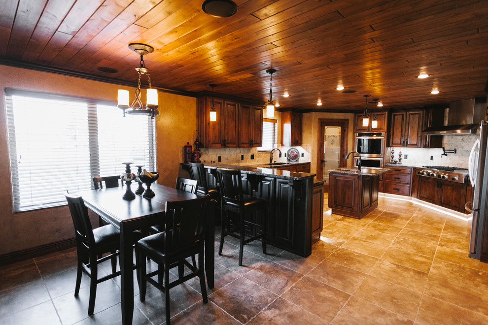 Inspiration for a transitional eat-in kitchen remodel with a drop-in sink, dark wood cabinets, quartz countertops, beige backsplash, custom tile backsplash, stainless steel appliances, beige walls and an island