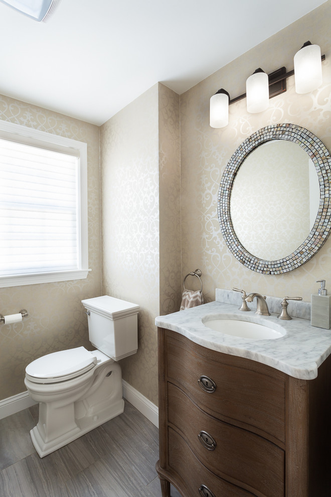 This is an example of a small traditional 3/4 bathroom in Boston with a one-piece toilet, beige walls, dark hardwood floors, an undermount sink and marble benchtops.