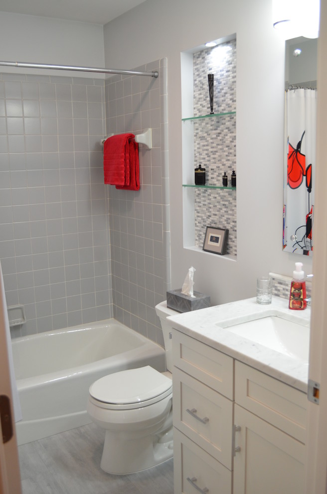 Bathroom - transitional gray tile and ceramic tile bathroom idea with shaker cabinets, white cabinets and marble countertops