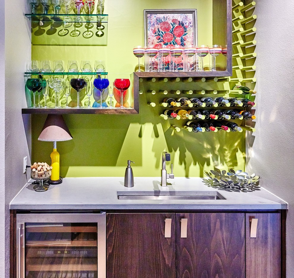 Photo of a small modern single-wall wet bar in Austin with an undermount sink, flat-panel cabinets, dark wood cabinets, concrete benchtops and green splashback.