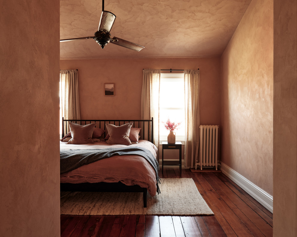 Inspiration for a mid-sized transitional master bedroom in Philadelphia with pink walls and dark hardwood floors.