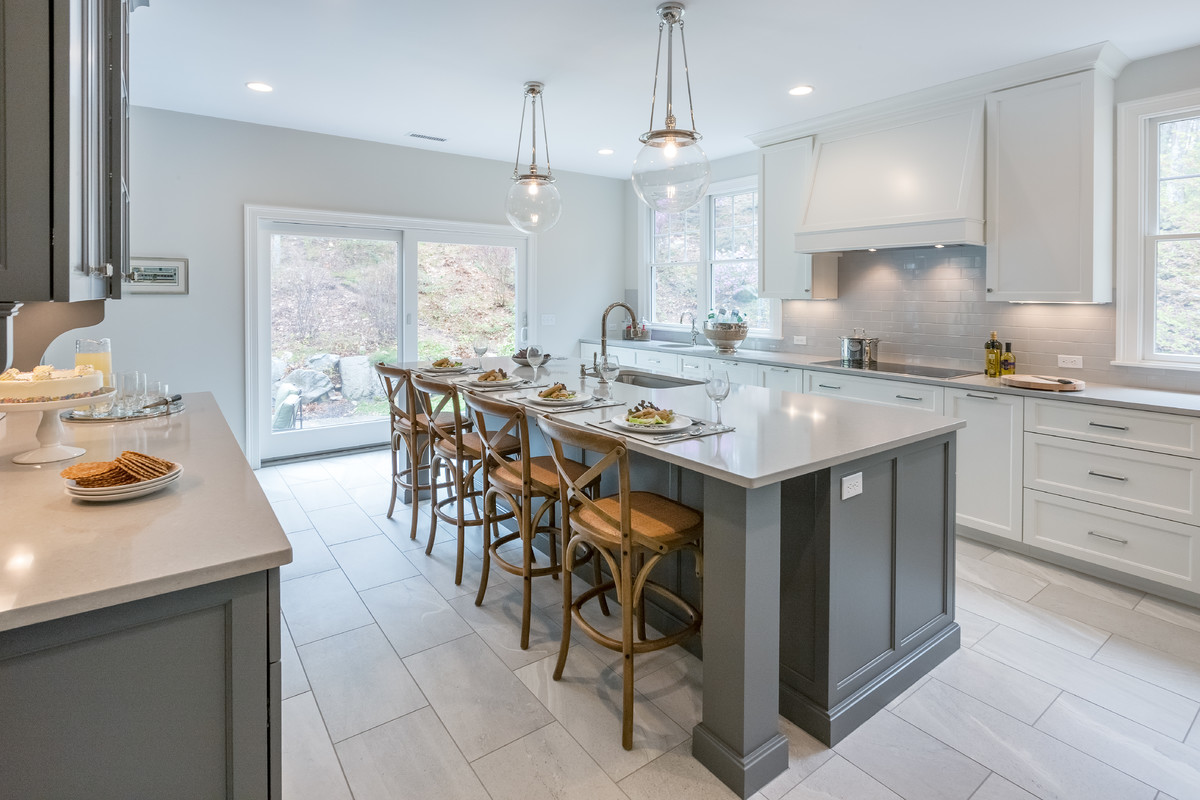 Inspiration for a transitional kitchen remodel in Boston with an undermount sink, gray cabinets, quartzite countertops, subway tile backsplash, stainless steel appliances and an island