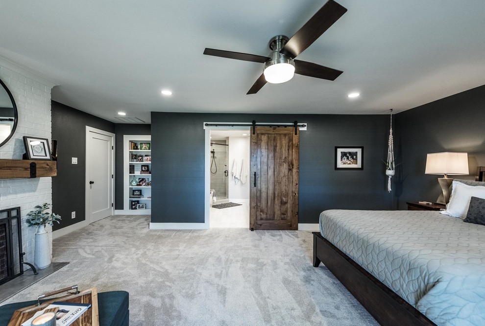 Inspiration for a large country master bedroom in Dallas with grey walls, carpet, a standard fireplace, a brick fireplace surround and beige floor.