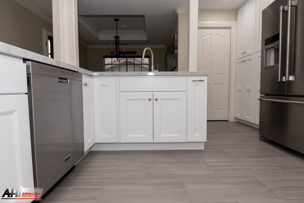Enclosed kitchen - mid-sized modern l-shaped cement tile floor and gray floor enclosed kitchen idea in Los Angeles with a drop-in sink, shaker cabinets, white cabinets, quartzite countertops, gray backsplash, mosaic tile backsplash, stainless steel appliances and white countertops