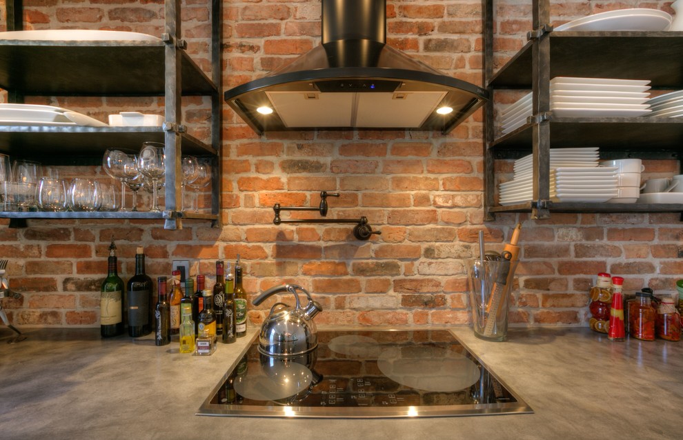 Inspiration for a mid-sized industrial l-shaped open plan kitchen in Orlando with an undermount sink, recessed-panel cabinets, brown cabinets, concrete benchtops, red splashback, brick splashback, stainless steel appliances, ceramic floors, with island and beige floor.