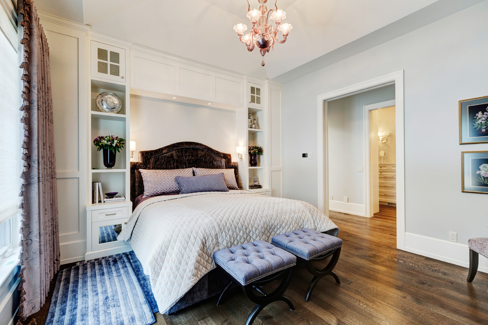 This is an example of a large traditional master bedroom in Calgary with grey walls and dark hardwood floors.