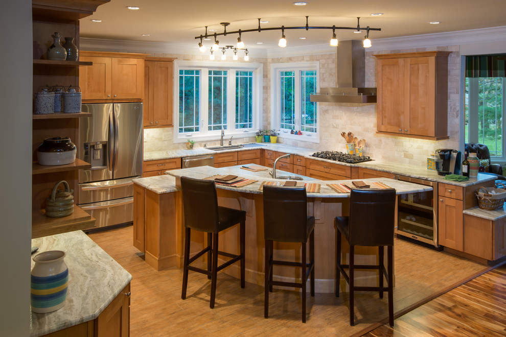 This is an example of a large arts and crafts u-shaped eat-in kitchen in DC Metro with an undermount sink, shaker cabinets, medium wood cabinets, granite benchtops, beige splashback, ceramic splashback, stainless steel appliances, ceramic floors and with island.