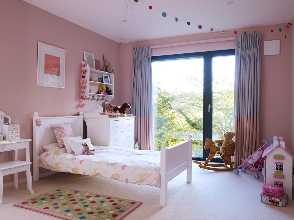 Photo of a mid-sized contemporary kids' bedroom for kids 4-10 years old and girls in Other with pink walls and carpet.