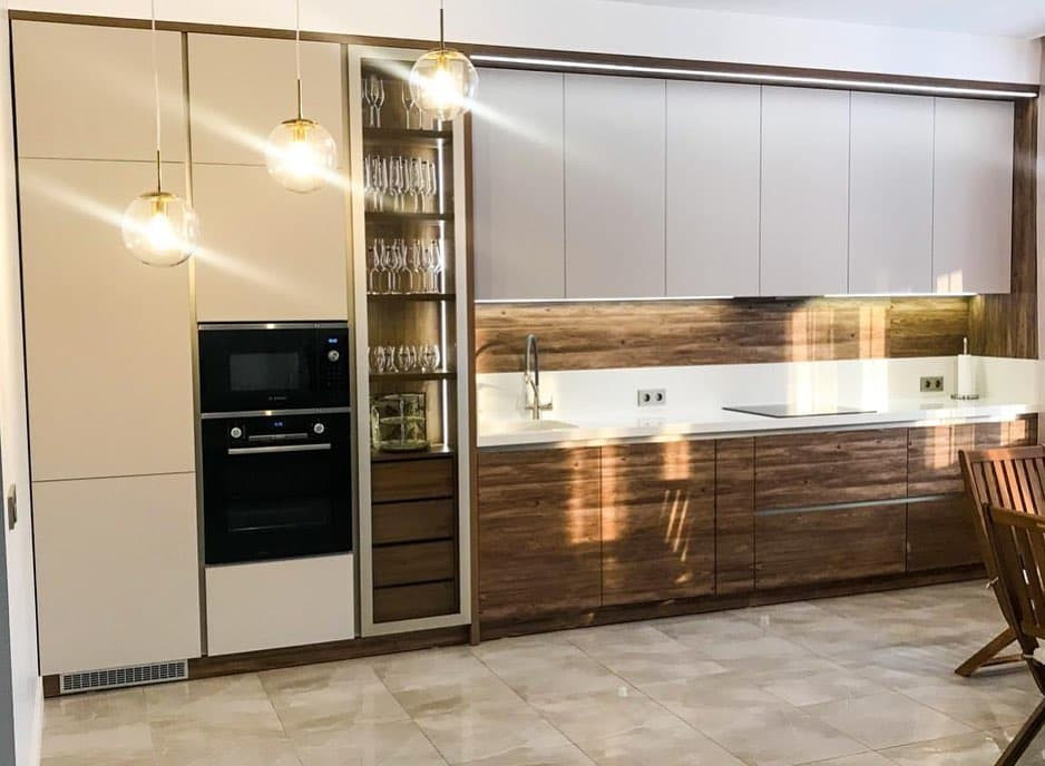 Large contemporary single-wall kitchen/diner in Moscow with an integrated sink, flat-panel cabinets, beige cabinets, composite countertops, brown splashback, wood splashback, stainless steel appliances, ceramic flooring, beige floors and white worktops.