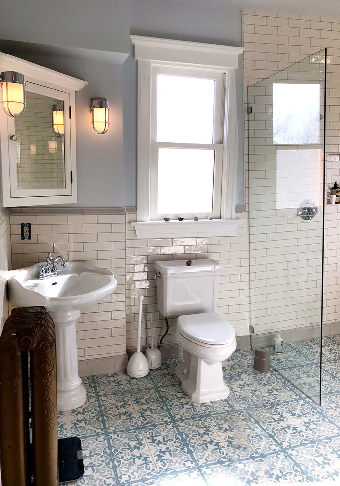 Inspiration for a mid-sized traditional master wet room bathroom in Seattle with shaker cabinets, white cabinets, a claw-foot tub, a two-piece toilet, ceramic tile, blue walls, cement tiles, a pedestal sink, blue floor and an open shower.