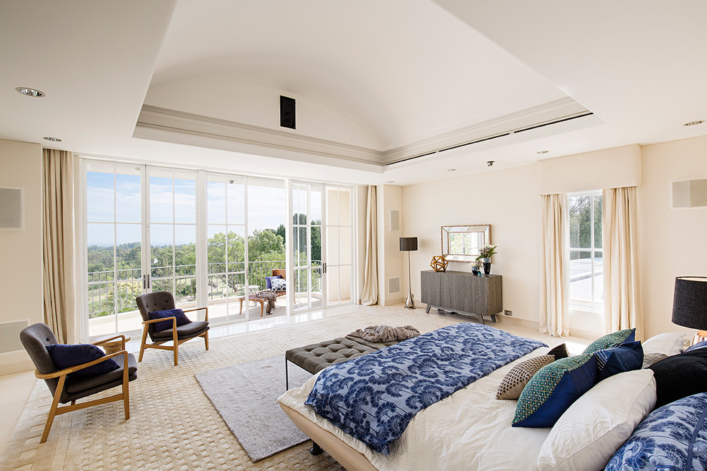 This is an example of a contemporary master bedroom in Melbourne with beige walls and no fireplace.