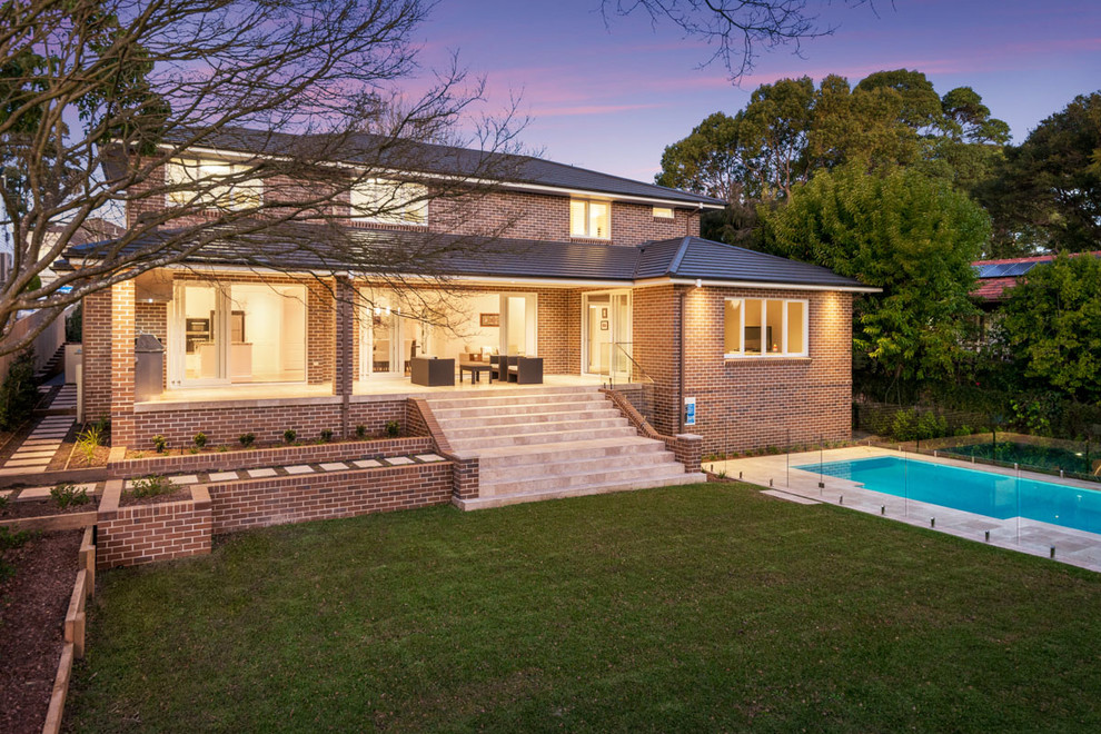 Inspiration for a large contemporary two-storey brick red exterior in Sydney with a hip roof.
