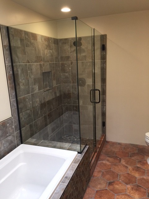 Inspiration for a small master bathroom in Phoenix with furniture-like cabinets, dark wood cabinets, a drop-in tub, an alcove shower, a two-piece toilet, multi-coloured tile, porcelain tile, beige walls, porcelain floors, a drop-in sink and wood benchtops.