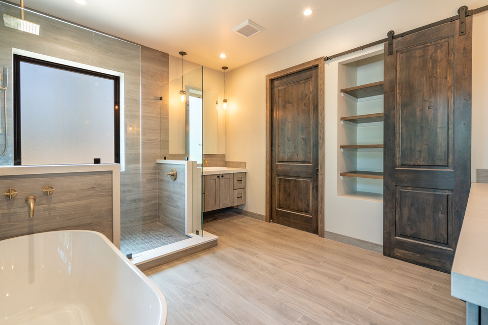 Large contemporary master bathroom in Phoenix with shaker cabinets, light wood cabinets, a freestanding tub, an open shower, gray tile, stone tile, white walls, porcelain floors, a vessel sink, quartzite benchtops, beige floor, an open shower and white benchtops.