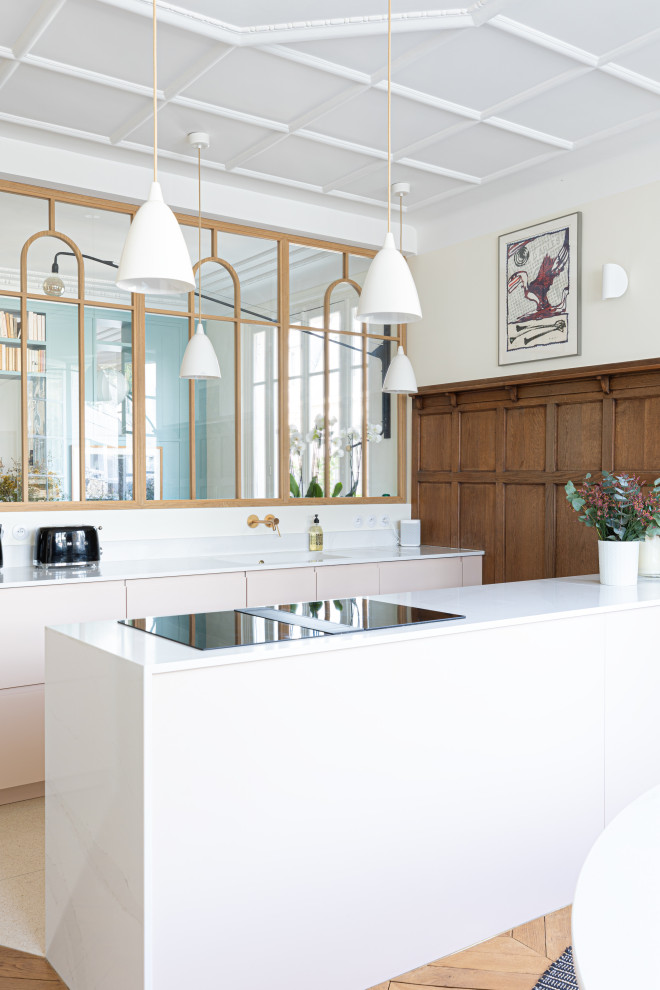 Photo of a large traditional galley open plan kitchen in Paris with a single-bowl sink, beaded cabinets, pink cabinets, quartz worktops, white splashback, engineered quartz splashback, integrated appliances, terrazzo flooring, an island, beige floors, white worktops and a coffered ceiling.