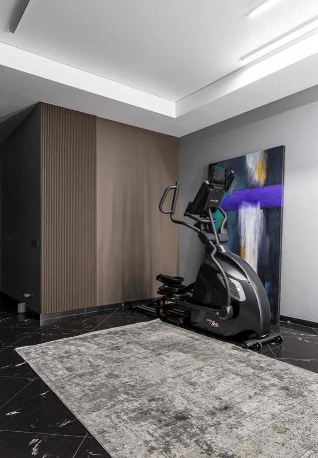 Expansive contemporary home weight room in Moscow with marble floors, black floor and recessed.