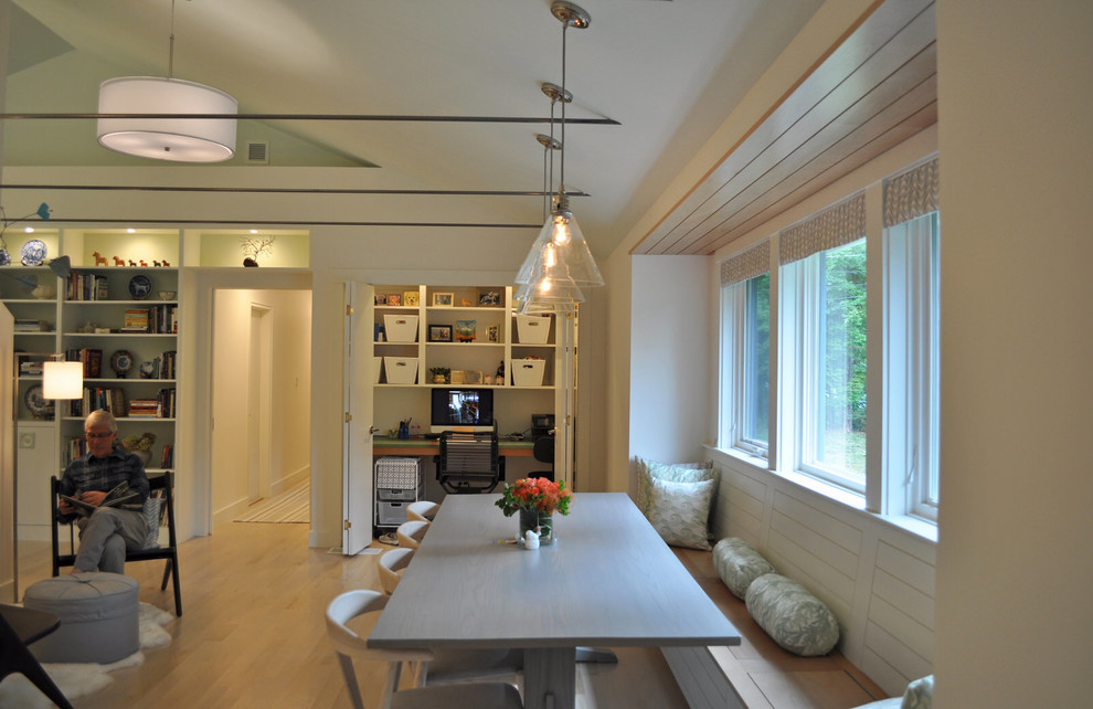 Photo of a mid-sized midcentury open plan dining in Boston with white walls and light hardwood floors.