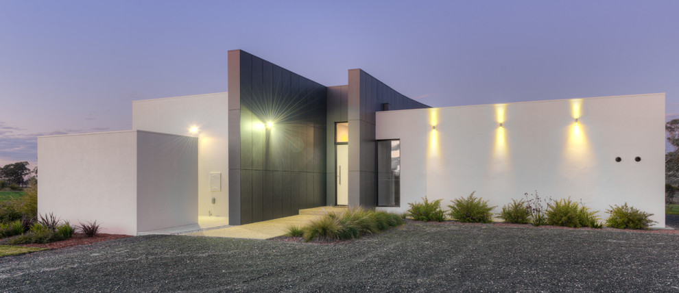 Mid-sized modern one-storey white exterior in Melbourne with concrete fiberboard siding and a flat roof.