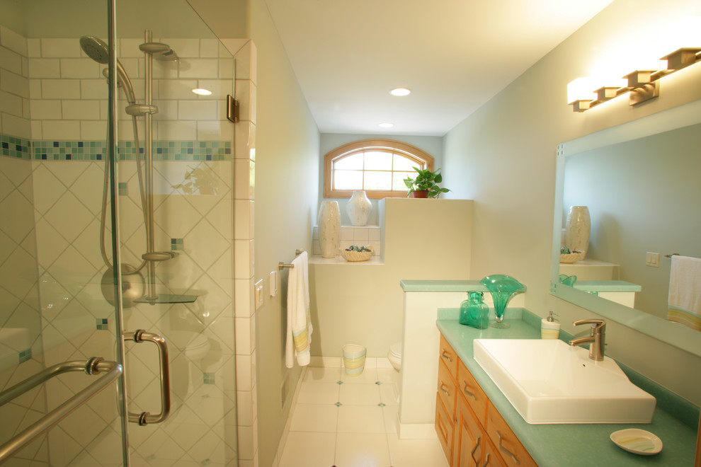 Design ideas for a mid-sized transitional master bathroom in Other with raised-panel cabinets, medium wood cabinets, an alcove shower, white tile, porcelain tile, white walls, porcelain floors, a vessel sink, glass benchtops, white floor, a hinged shower door and turquoise benchtops.