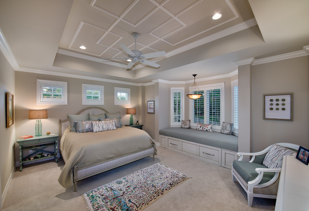 Design ideas for a mid-sized beach style guest bedroom in Miami with beige walls and carpet.