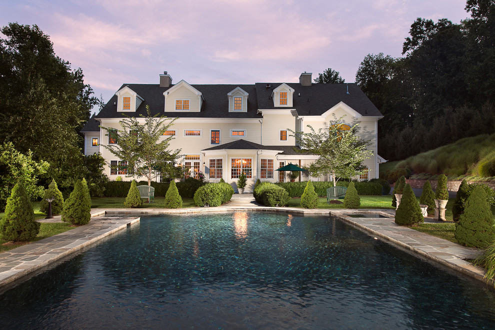 Inspiration for a traditional pool in New York with natural stone pavers.