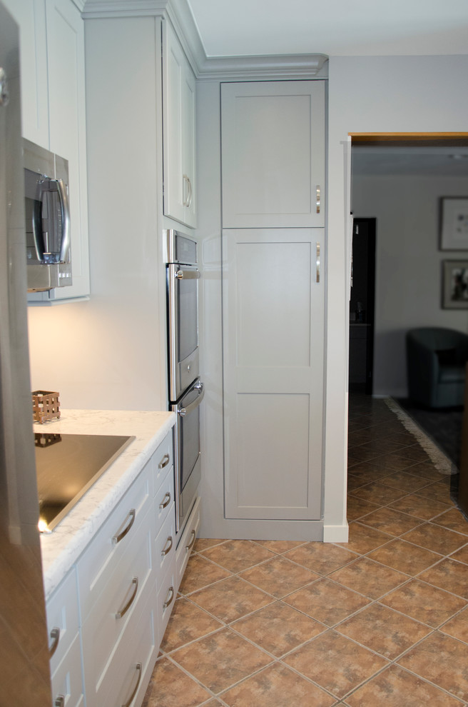 Mid-sized transitional u-shaped open concept kitchen photo in Miami with an undermount sink, shaker cabinets, gray cabinets, quartzite countertops, gray backsplash, porcelain backsplash, stainless steel appliances and an island